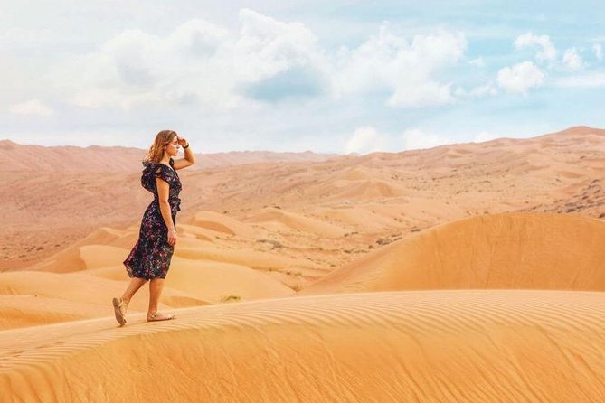 Camel Trekking and Morning Safari with Sand Boarding - Sandboarding down a red dune