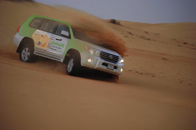 Desert Safari Tour, Quad Bike with BBQ Dinner & Show from Dubai - Sandboarding beneath the setting sun