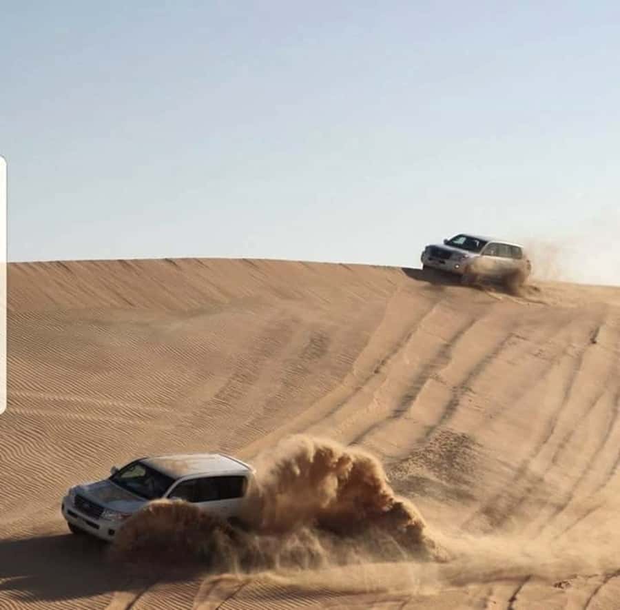 Doha: Desert Safari Dune Bashing, Sandboarding, & Camel Ride - Sandboarding and the route to the Inland Sea