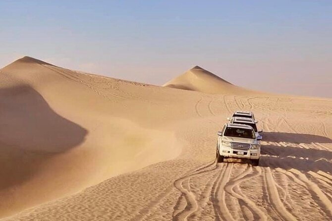 Doha: Half Day Desert Safari with Camel Ride and Inland Sea Tour - Dune bashing at Sealine Beach