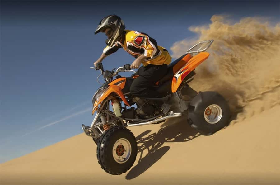 Dubai: Desert Safari, Quad Bike, Camel Ride and Sandboarding - Quad biking across the open desert