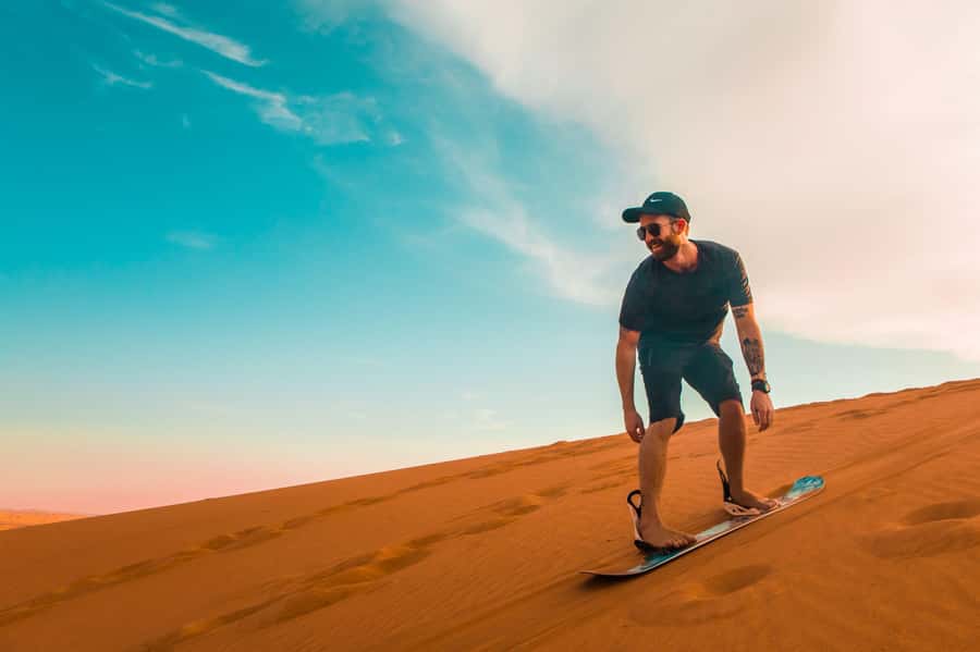 Dubai: Desert Safari, Quad Bike, Sandboarding, Camels & BBQ - Starting with a hotel pickup in Dubai