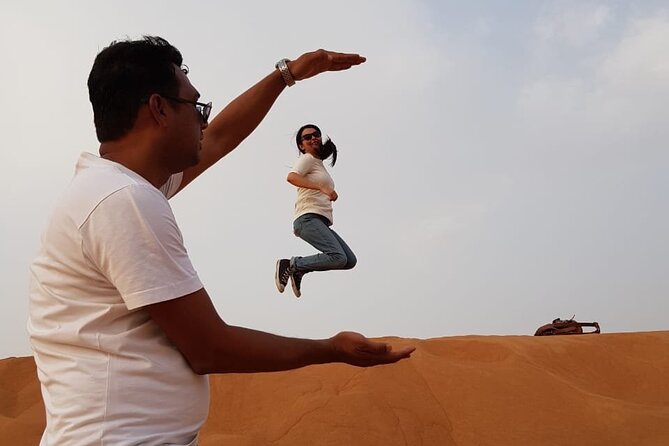 Dubai Desert Safari: Tanoura Show, Dune Bashing and BBQ Dinner - Sandboarding adds a quick burst of fun