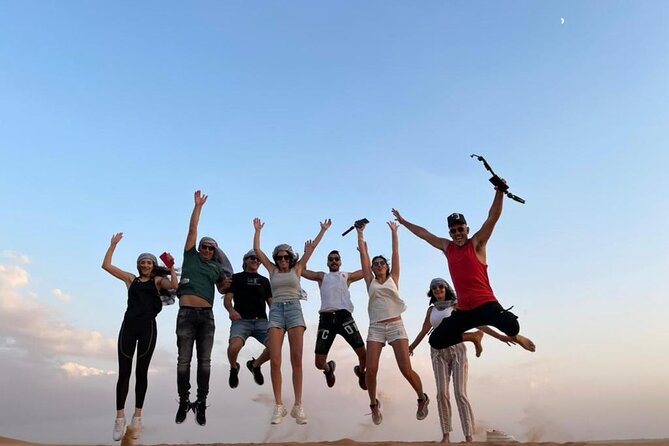 Dubai Evening Desert Safari With Transfers Dune Bashing & Dinner - Sandboarding and the sunset pause