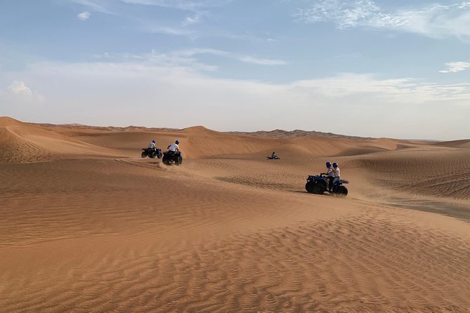 Dubai: Unique SUNSET Quad Bike Red Dunes Safari - A short camel ride for a slower view