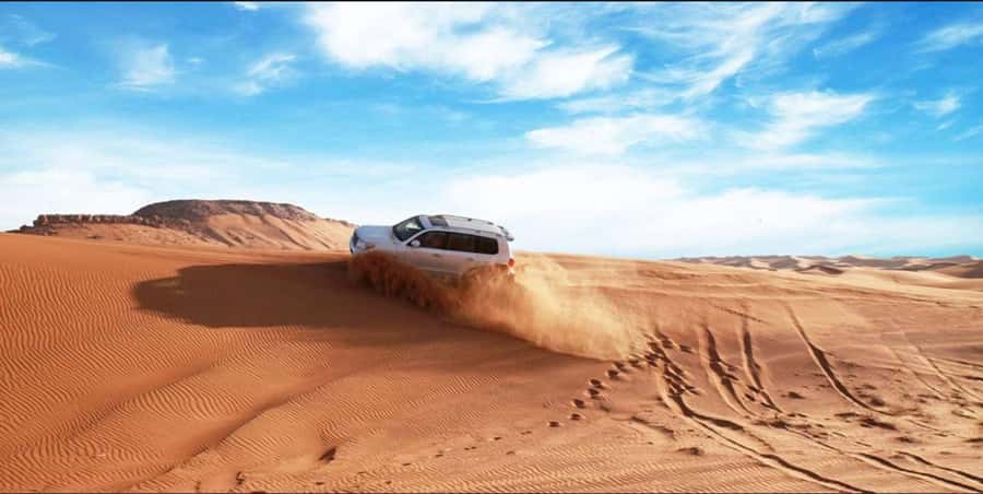 Quad Bike/Buggy, Desert Safari, Camel Ride, Dune Bashing - Sandboarding is simple, funny, and surprisingly tiring