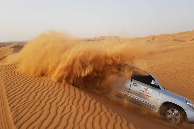 Red Dunes Desert Safari with BBQ Dinner - Sandboarding and the sunset photo stop