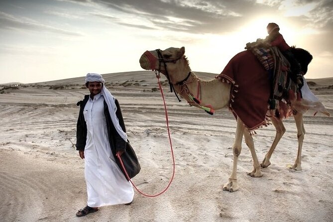 Thrilling 4-Hour Dune Bashing & Camel Ride Safari to Inland Sea - A short camel ride at Sealine Beach